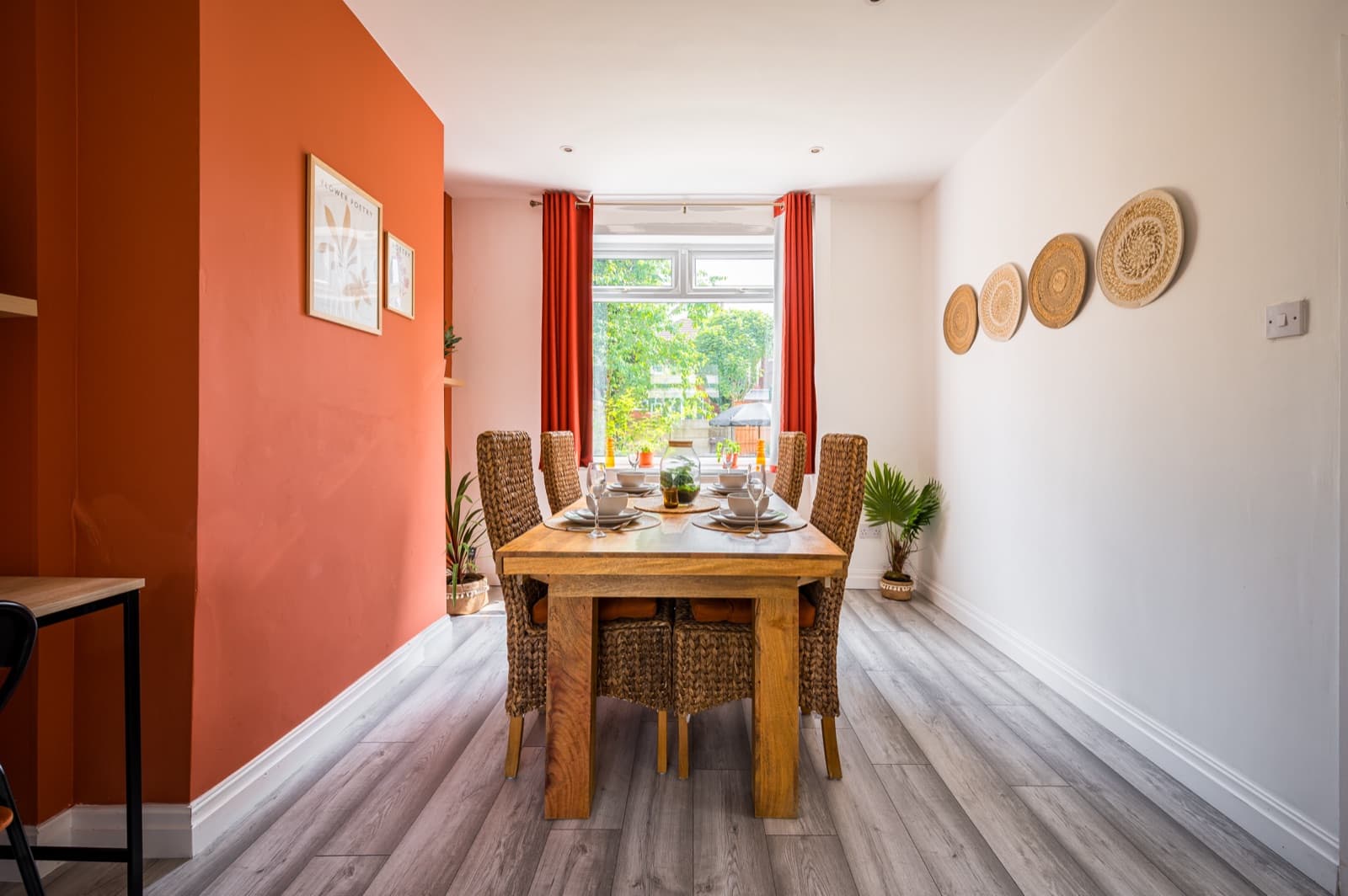 A bright dining room with an oak table set for four